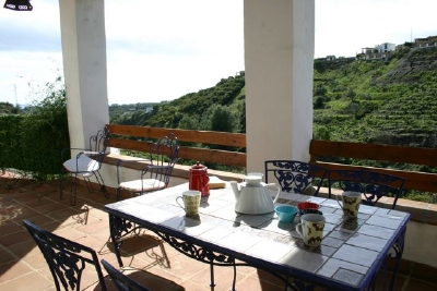 Another perspective of the front terrace with views of the countryside.